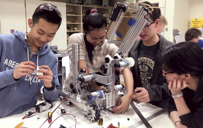 robotics team members work on their robot